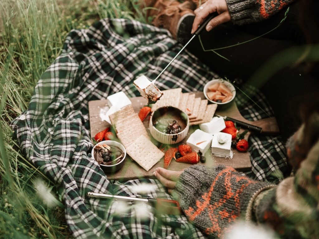 Help And Tips For Your First Camping Trip.
You’ve finally decided to bite the bullet and go on your first camping trip. But what now? 

It may feel like an impossible task: working out what to pack, how to put up a tent, planning what to do once you arrive and then packing everything up again. 

Trust me, camping isn’t as difficult as it seems! 

Whether you’re a teenager going on your first camping trip without parents, or a family who’ve never camped before, follow these tips and tricks to make the whole experience much smoother.

Let’s start at the very beginning- packing the car

I would recommend using a checklist when packing for camping, as there are always a few vital extras you’d forget otherwise. Use our Beginners Guide for What to take Camping (CG) as a guide and then adjust it to suit the specific needs of your group as well as the weather forecast. 

Now that all your bags are waiting to be packed into the car, you may be wondering how you can fit it all in. I would recommend packing the heavy stuff: your tent, gazebo and cooking equipment at the bottom so that they don’t crush any of your other bags. 

But be sure to position them near the door of the boot so they are easy to access as these will be the first things you need when you’re setting up camp.

Make sure you position your food near the top of the boot so that it doesn’t get crushed. We normally wedge the food bags between other items so that they don’t get dislodged when the car goes over a bump. You could also put the food bags at people’s feet in the car. This also means the food is easily reachable for car journey snacking!

I would also recommend surrounding the children with any duvets, blankets or pillows. The back seats have a lot of space that people often forget to utilise, saving you precious space in the boot. Giving them bedding to snuggle up in will also make for a much more comfortable car ride, especially if you’re driving at night.

Tips for saving space

If you’re running low on space either because your boot is too small, or like me you’re a chronic overpacker, then you could use compression bags. These are great for saving space as they compress items like clothes, sleeping bags or bulky jackets. You either use a vacuum to remove the air, or squeeze the air out of a one-way pressure valve using your hands. 

Bear in mind that you’ll need to get everything back in the car afterwards, without a hoover to help you. 

If you don’t want to wrinkle your clothes then you could ditch the compression bags and just roll up your clothes instead. I found this surprisingly revolutionary and it saves so much more space than folding.

If you really need the extra space, then there are a few other options. 

You could invest in a roofbox: we normally use ours for packing the tent and other really bulky items like chairs. 

For even more space, you could even invest in a small road towable trailer. This means you essentially have another boot to pack your bags in, but obviously this will only work for you if you’ve somewhere to store it once you get home. 

Packing light takes a lot of effort and it is something that gets easier once you have gone on a few camping trips.

Before you leave don’t forget to plan!

Another vital part of the camping preparation process is planning your trip in advance. 

I would recommend downloading a map of the campsite and surrounding countryside, as you can never rely on mobile service in the great outdoors. This will mean you know where to go walking and places of interest to visit such as historical monuments, beaches, nature reserves or activity centres for the kids. 

Before you leave, why not research the forest walks in the surrounding countryside- there are usually loads! If you research them online, they often come with a rating of how taxing the route is (especially useful when camping with kids who get tired easily), and approximately how long the trip will take to complete. 

If possible, plan a pub stop half way into your walk for lunch (call to book, as pubs can get booked up quickly near busy campsites especially on summer weekends).

Setting up the tent

You’ve successfully packed the car, planned some activities and have finally reached your campsite. 

The first thing to do is to find a place to pitch. You're looking for level ground without rocks, sticks and lumps. You could pack a small stiff broom to sweep the ground clean before you pitch so you know your tent will be on a clean bump free pitch. 

If you can find level ground, then a gentle slope is fine. Just make sure you pitch your tent orientated in a way that your feet are down hill when you sleep.

The next thing to do is assemble your tent. 

If it’s your first time camping then I’d definitely recommend finding the time to practice putting up the tent in the back garden or a local park, so you have an idea on how to make your shelter without issue upon arrival. This is also a great time to check you have enough tent pegs and that nothing in the tent is broken or faulty. 

Once you have put up the tent and unpacked, if you feel like your pitch could still use a bit of upgrading why not check out my blog on how to glam up your pitch (CE).

What to do once you’re settled in

The hardest bit is over! Now is time to relax around the fire or in your expertly put up tent. 

One of the biggest joys of camping is sitting in the middle of the countryside and experiencing the natural world. For an enjoyable camping trip I would recommend packing a comfortable camping chair, these are undoubtedly worth the space they take up in the car! It means you can relax by the campfire, sip tea in the morning and chat with friends without getting muddy. 

Why not pack a good book (or two) as well. Camping is the perfect time to get started on that book you’ve been putting off for months – just don’t forget your head-torch for reading at night. 

Once the sun has set, camping fun doesn’t have to end, check out The magic of camping after dark (CE) for some ideas for what to do on a camp evening.

Packing up

Start by packing away everything in the tent and making sure it is empty. 

Then open any doors of the tent to prevent a vacuum forming when you pack it up and to let all the air out. 

Next, take out all the pegs and guy lines- tie these away so that they don’t get all tangled when you try to put up the tent again. Remember that camping etiquette is to push back the soil or grass when you pull out a tent peg.

If your tent has poles (rather than being a pop up tent which you just fold up and twist so that it is the same shape as the bag) then take them out from the back first to push air out of the tent. 

Finally it is time to fold up your tent, fold it so that it is the same width as the bag you’re trying to fit it in. 

Then squeeze out as much air as you can, place your bag of poles and pegs on top of the tent and roll it up to wrap the poles in the middle. F

inally, just put your tent in the bag. 

Easy peasy!

Finally....

Grab some last minute snacks or a quick picnic once you finished packing up. 

This will keep those hunger monsters at bay for the drive home. 

Good luck on your first camping trip. Hopefully reading this will help to relieve some of the stress about packing and planning for camping. You’ll feel like an expert in no time- with your tent set up and the car full.
